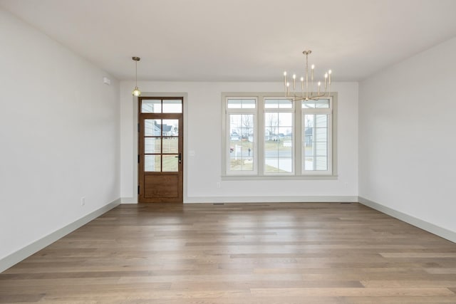 135 Radnor Ct, Rockingham, VA 22801 - unfurnished dining area with baseboards, a chandelier, and wood finished floors