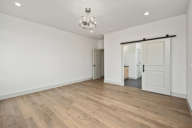 135 Radnor Ct, Rockingham, VA 22801 - unfurnished bedroom with recessed lighting, light wood-style floors, a chandelier, and a barn door