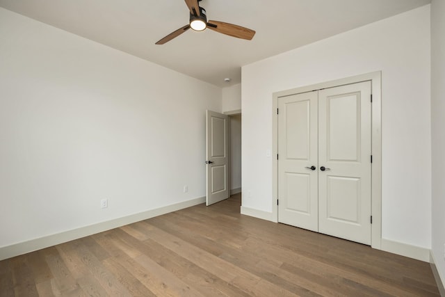 135 Radnor Ct, Rockingham, VA 22801 - unfurnished bedroom with a closet, a ceiling fan, wood finished floors, and baseboards