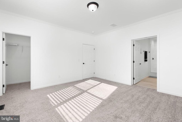 unfurnished bedroom with baseboards, carpet floors, and crown molding