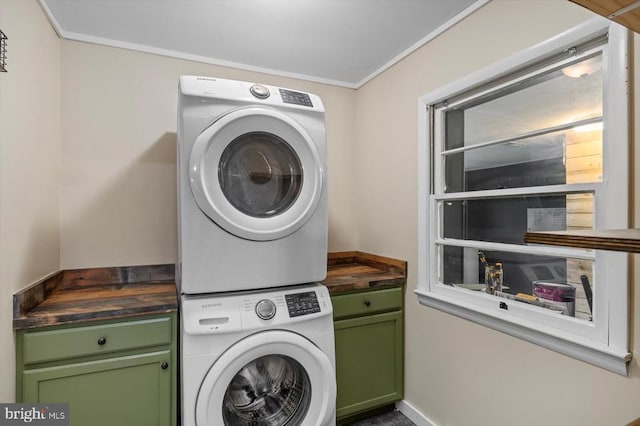 7615 Morris Rd, Spotsylvania, VA 22551 - laundry room with estacked washer and dryer, cabinet space, crown molding, and baseboards