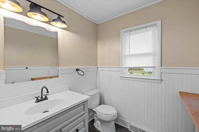 7615 Morris Rd, Spotsylvania, VA 22551 - half bathroom featuring a wainscoted wall, toilet, vanity, and ornamental molding