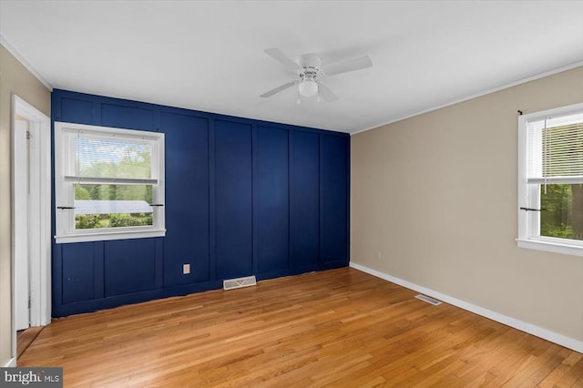 7615 Morris Rd, Spotsylvania, VA 22551 - unfurnished room with light wood-style flooring, a ceiling fan, ornamental molding, and baseboards