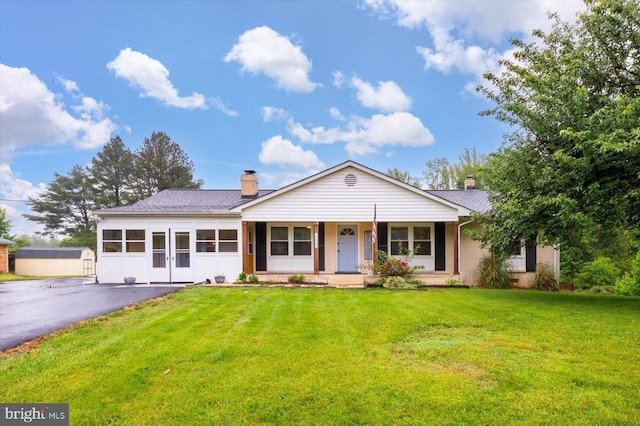 7615 Morris Rd, Spotsylvania, VA 22551 - view of front of property with a front lawn, a chimney, covered porch, and driveway