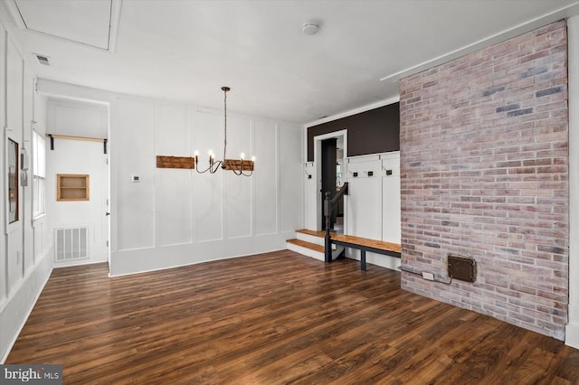 7615 Morris Rd, Spotsylvania, VA 22551 - unfurnished room with wood finished floors, a decorative wall, a smoke detector, and a chandelier