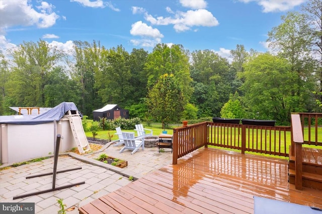 7615 Morris Rd, Spotsylvania, VA 22551 - wooden terrace featuring a patio, an outdoor fire pit, and a lawn