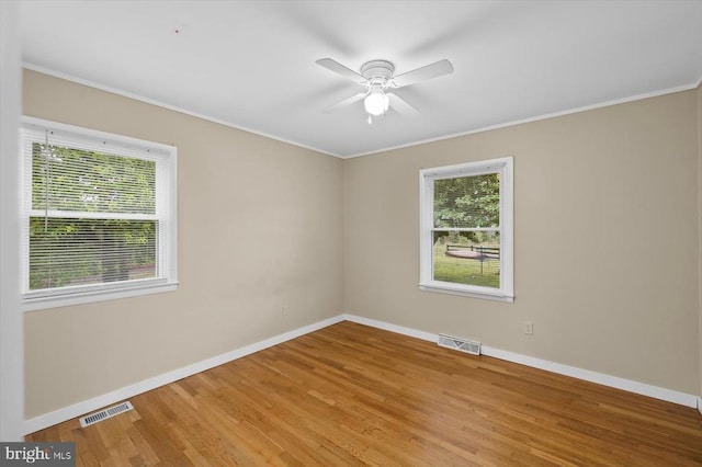 7615 Morris Rd, Spotsylvania, VA 22551 - spare room featuring plenty of natural light, baseboards, crown molding, and wood finished floors