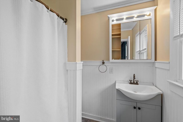 7615 Morris Rd, Spotsylvania, VA 22551 - full bathroom with vanity, crown molding, a wainscoted wall, a decorative wall, and curtained shower