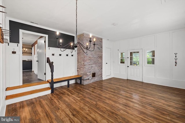 7615 Morris Rd, Spotsylvania, VA 22551 - entrance foyer with a decorative wall, a chandelier, wood finished floors, and ornamental molding