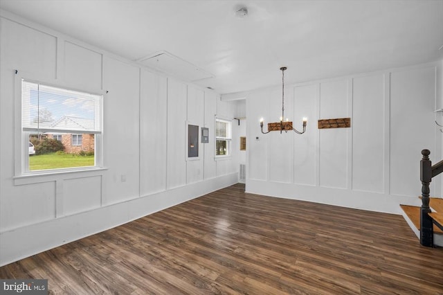 7615 Morris Rd, Spotsylvania, VA 22551 - empty room featuring a decorative wall, a chandelier, dark wood-style floors, electric panel, and a smoke detector