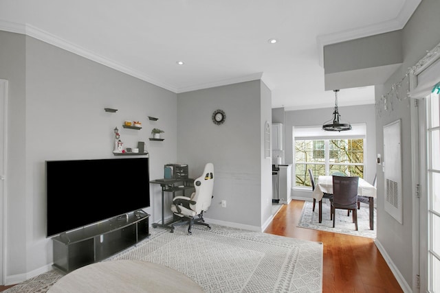 bedroom featuring recessed lighting, wood finished floors, baseboards, and ornamental molding