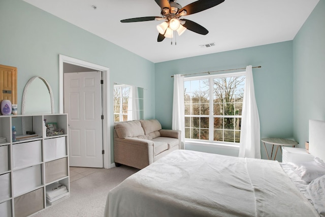 carpeted bedroom with visible vents and a ceiling fan