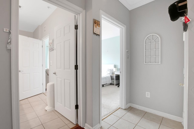 hallway with light tile patterned floors and baseboards