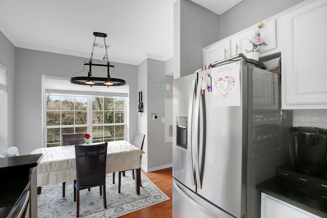 kitchen with white cabinetry, crown molding, wood finished floors, and stainless steel fridge with ice dispenser