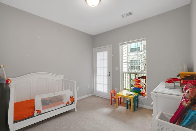 bedroom with baseboards, visible vents, and light carpet