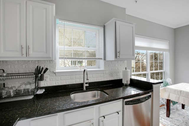 kitchen featuring a sink, backsplash, white cabinetry, crown molding, and dishwasher