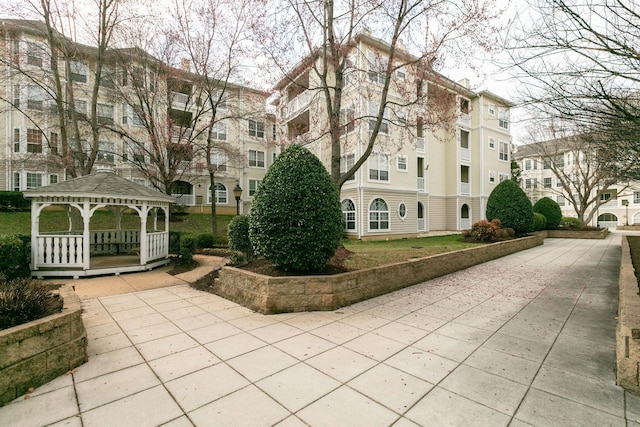 surrounding community with a gazebo and driveway