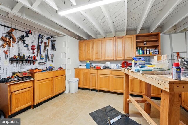 kitchen with open shelves, light countertops, and light tile patterned flooring