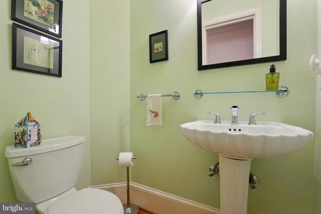 half bathroom featuring toilet