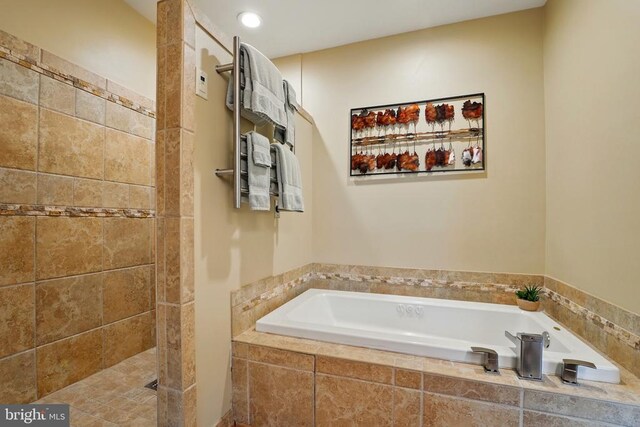 full bath featuring a bath and tiled shower