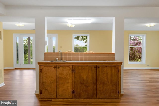 531 Parkview Estates Rd, Luray, VA 22835 - kitchen featuring tile countertops, wood finished floors, brown cabinets, a sink, and tasteful backsplash