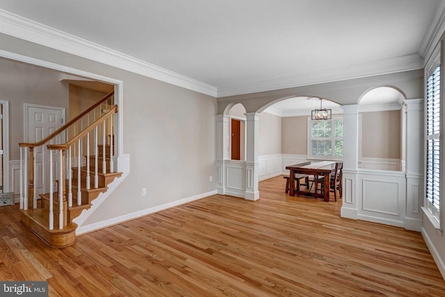 11211 Spring Meadow Blvd, Fredericksburg, VA 22407 - empty room with light wood-type flooring, arched walkways, a decorative wall, decorative columns, and ornamental molding