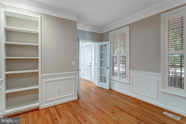 11211 Spring Meadow Blvd, Fredericksburg, VA 22407 - unfurnished room with crown molding, wood finished floors, wainscoting, healthy amount of natural light, and french doors