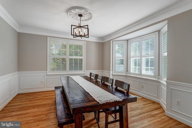 11211 Spring Meadow Blvd, Fredericksburg, VA 22407 - dining room featuring plenty of natural light, a chandelier, light wood-type flooring, crown molding, and a wainscoted wall