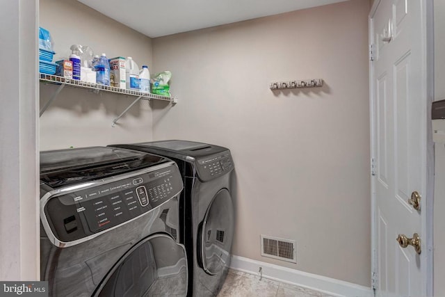 11211 Spring Meadow Blvd, Fredericksburg, VA 22407 - laundry area with washing machine and dryer and tile patterned floors