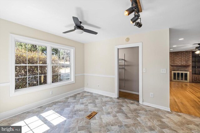 148 Red Hill Rd, Orange, VA 22960 - unfurnished bedroom with a brick fireplace, baseboards, a walk in closet, and ceiling fan
