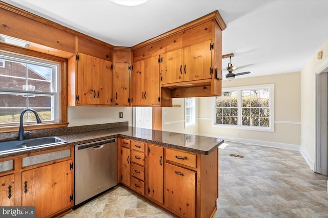 148 Red Hill Rd, Orange, VA 22960 - kitchen with stainless steel dishwasher, a sink, a peninsula, a ceiling fan, and brown cabinets