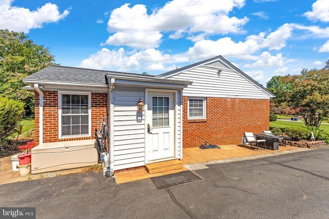 148 Red Hill Rd, Orange, VA 22960 - view of front of property featuring brick siding, a wooden deck, a shingled roof, and a patio