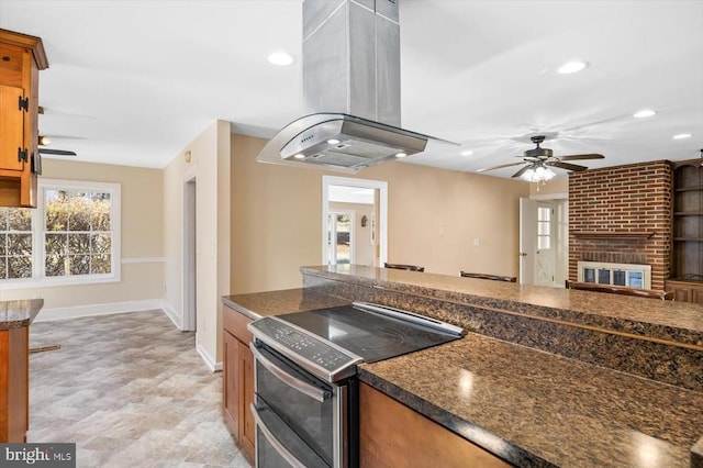 148 Red Hill Rd, Orange, VA 22960 - kitchen with double oven range, island range hood, a ceiling fan, baseboards, and dark countertops