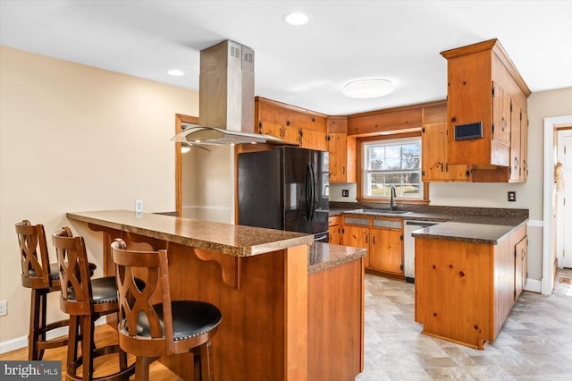 148 Red Hill Rd, Orange, VA 22960 - kitchen featuring black fridge, a peninsula, a sink, island range hood, and brown cabinets