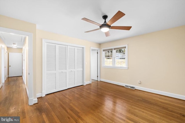 148 Red Hill Rd, Orange, VA 22960 - unfurnished bedroom with attic access, baseboards, hardwood / wood-style flooring, a closet, and a ceiling fan