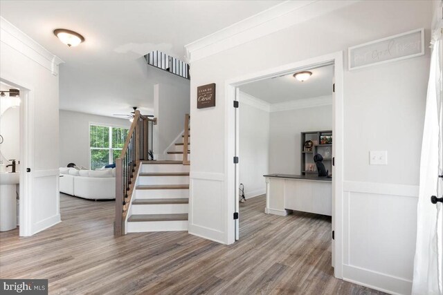 5509 Bazzanella Dr, Mineral, VA 23117 - stairway featuring wood finished floors, ceiling fan, and ornamental molding