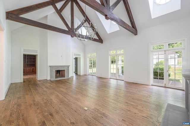 2621 Coopers Ln, Charlottesville, VA 22902 - unfurnished living room featuring a skylight, wood finished floors, high vaulted ceiling, a fireplace, and beamed ceiling
