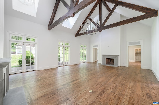 2621 Coopers Ln, Charlottesville, VA 22902 - unfurnished living room with a fireplace with raised hearth, a skylight, beamed ceiling, and high vaulted ceiling