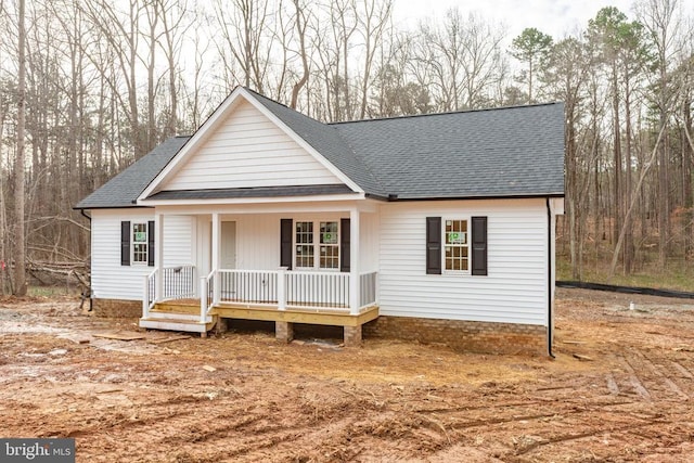 view of front of home with a shingled roof and a porch