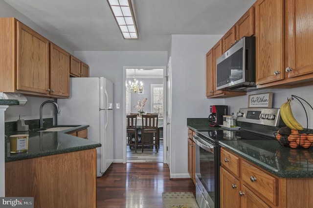 8802 Dundee Dr, Fredericksburg, VA 22408 - kitchen featuring stainless steel appliances, a sink, dark wood-style flooring, and brown cabinets