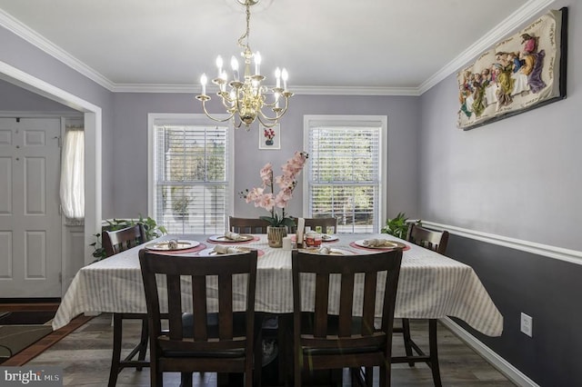 8802 Dundee Dr, Fredericksburg, VA 22408 - dining area with a chandelier, plenty of natural light, crown molding, wood finished floors, and baseboards
