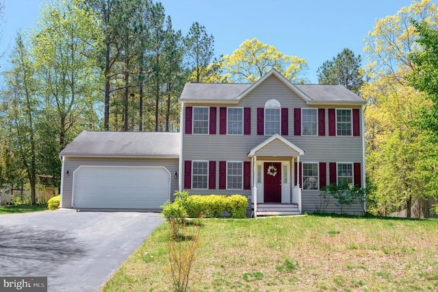 8802 Dundee Dr, Fredericksburg, VA 22408 - colonial inspired home featuring asphalt driveway, an attached garage, and a front yard