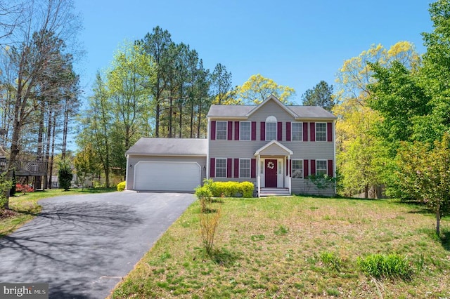 8802 Dundee Dr, Fredericksburg, VA 22408 - colonial home with a garage, asphalt driveway, and a front lawn