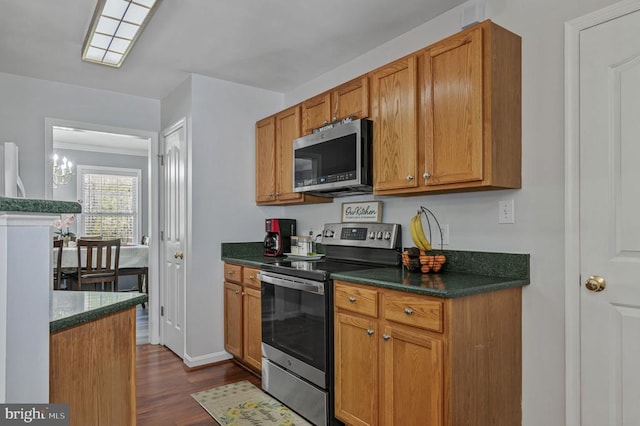8802 Dundee Dr, Fredericksburg, VA 22408 - kitchen featuring appliances with stainless steel finishes, dark wood-style flooring, dark countertops, and brown cabinets
