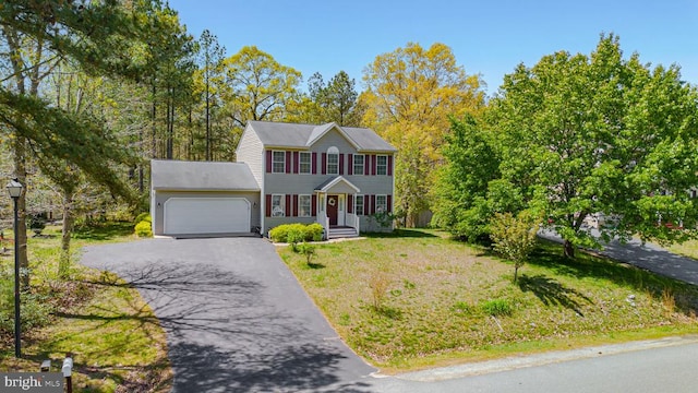8802 Dundee Dr, Fredericksburg, VA 22408 - colonial home featuring a garage, asphalt driveway, and a front lawn