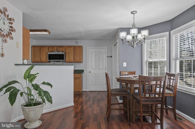 8802 Dundee Dr, Fredericksburg, VA 22408 - dining space with a chandelier, dark wood-style floors, and baseboards