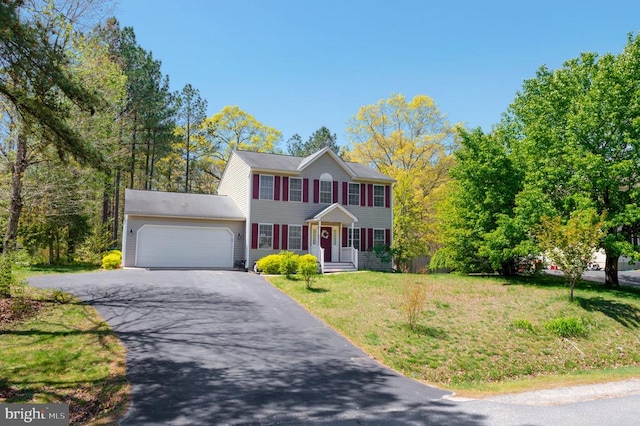 8802 Dundee Dr, Fredericksburg, VA 22408 - colonial inspired home with an attached garage, driveway, and a front lawn