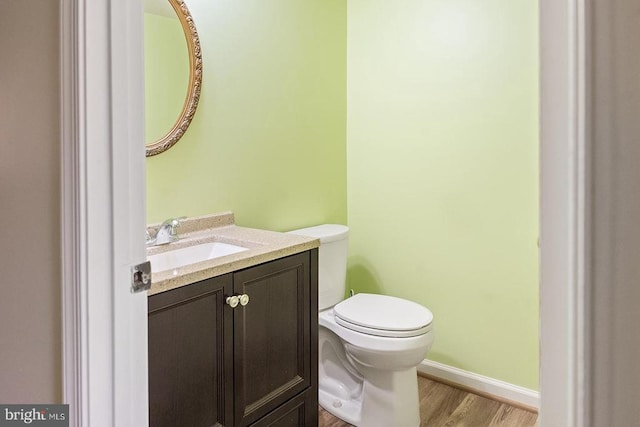 14026 Eggbornsville Rd, Culpeper, VA 22701 - half bath with toilet, baseboards, vanity, and wood finished floors