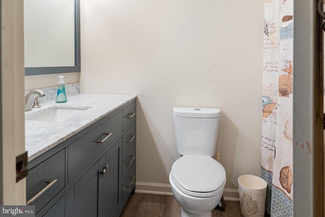14026 Eggbornsville Rd, Culpeper, VA 22701 - bathroom featuring toilet, baseboards, vanity, and wood finished floors