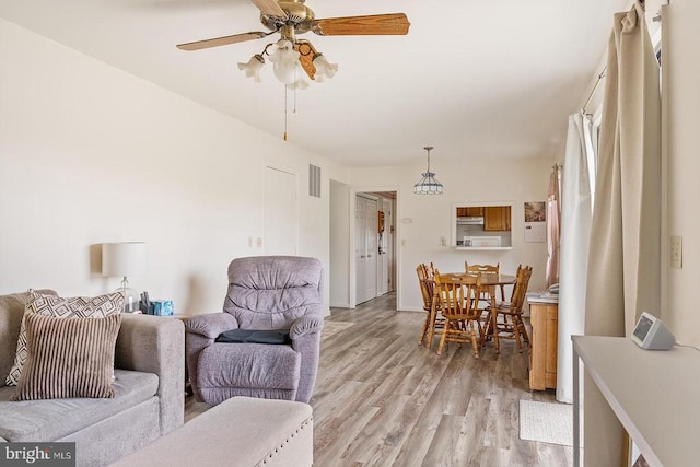14026 Eggbornsville Rd, Culpeper, VA 22701 - living area featuring light wood finished floors, visible vents, and ceiling fan